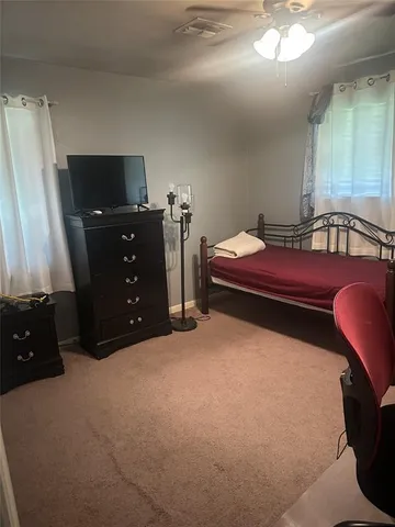 a bedroom with a bed and a television