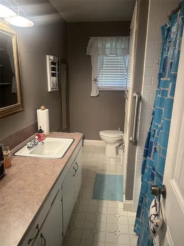 a bathroom with a sink a toilet and a mirror