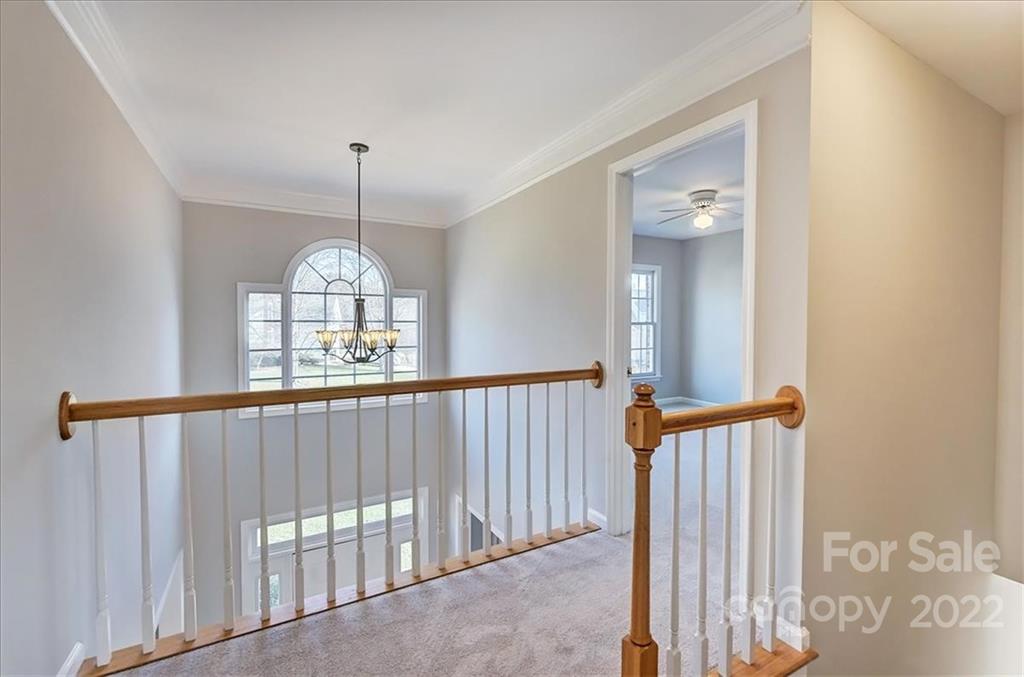 10409 Friarsgate Road Huntersville, NC 28078 - Photo 13 of 30 a view of a hallway with wooden floor and staircase