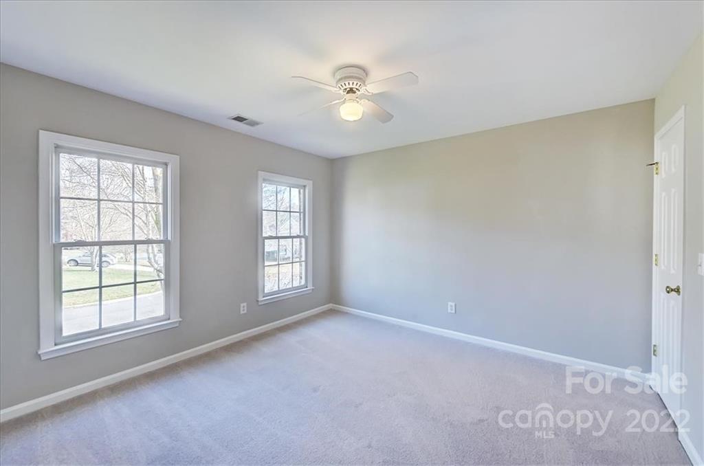 10409 Friarsgate Road Huntersville, NC 28078 - Photo 21 of 30 an empty room with windows and ceiling fan