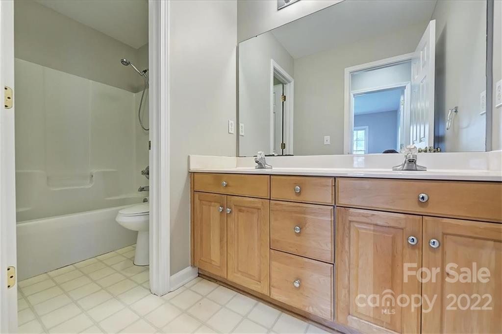 10409 Friarsgate Road Huntersville, NC 28078 - Photo 22 of 30 a bathroom with a sink a toilet and shower