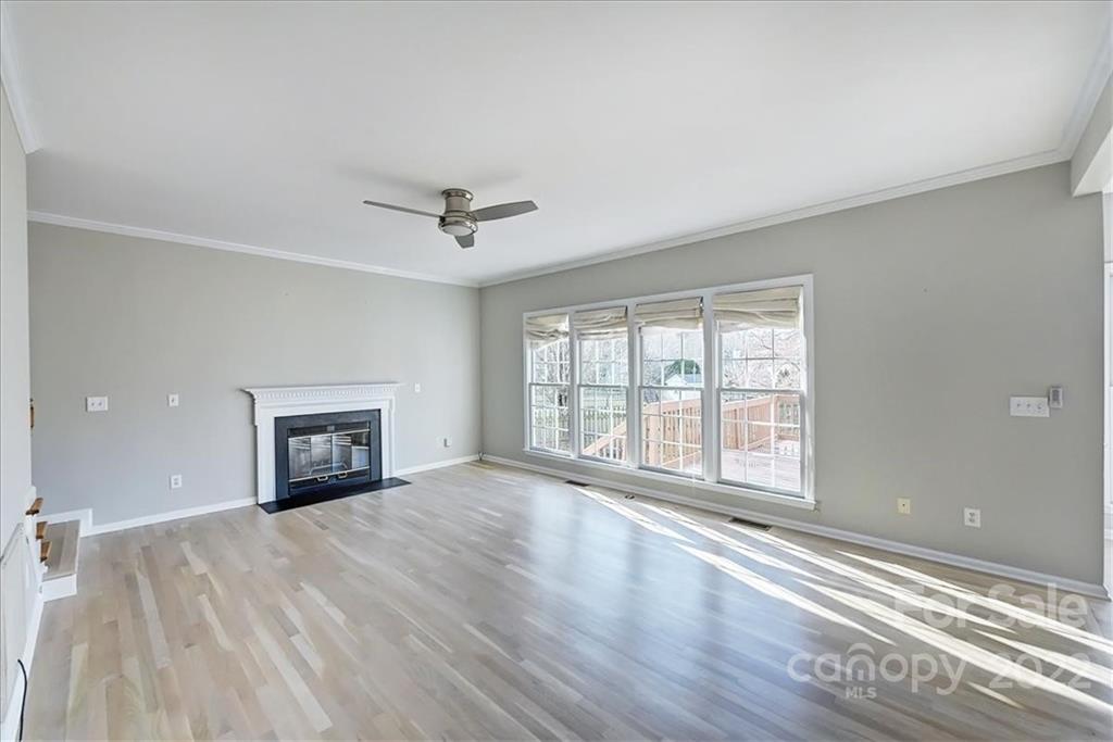 10409 Friarsgate Road Huntersville, NC 28078 - Photo 6 of 30 a view of an empty room with a fireplace and a window
