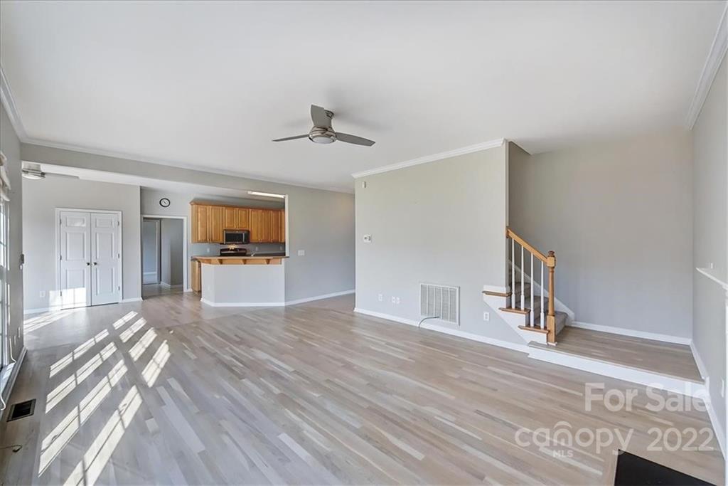 10409 Friarsgate Road Huntersville, NC 28078 - Photo 7 of 30 a view of a hallway with wooden floor and a kitchen