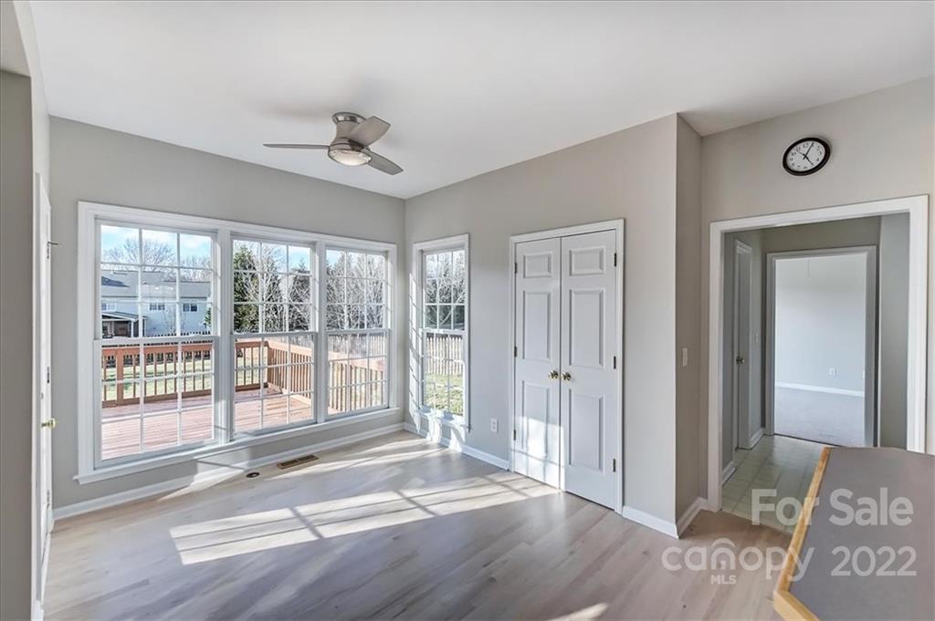 10409 Friarsgate Road Huntersville, NC 28078 - Photo 9 of 30 a view of an empty room with wooden floor and a window