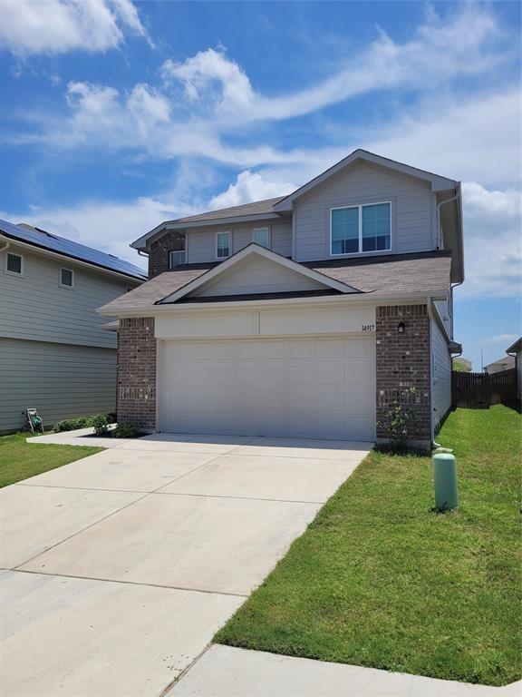 14917 Gypsum Mill Road Manor, TX 78653 - Photo 1 of 28 A well-maintained facade with a two-car garage offers inviting curb appeal.