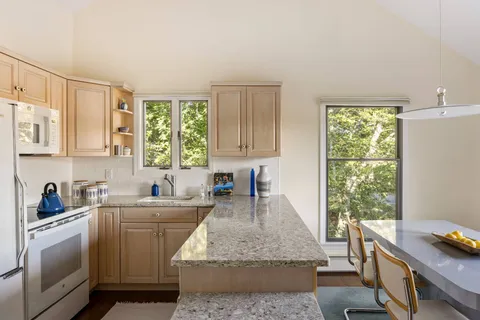a kitchen with a sink stove and window