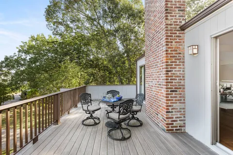 a view of balcony with wooden floor and outdoor seating