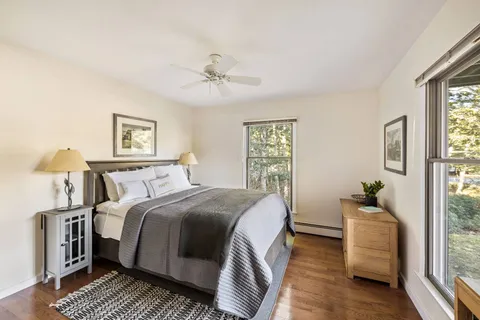 a bedroom with a bed and wooden floor