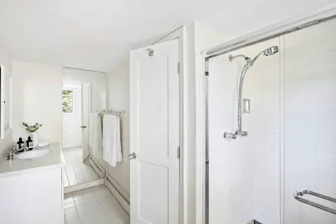 a bathroom with a shower and a glass door