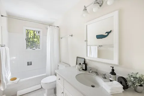 a bathroom with a sink mirror toilet and bathtub
