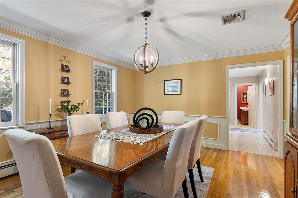 18 Bramley Hill Road Windham, NH 03087 - Photo 20 of 42 a dining room with furniture a chandelier and wooden floor