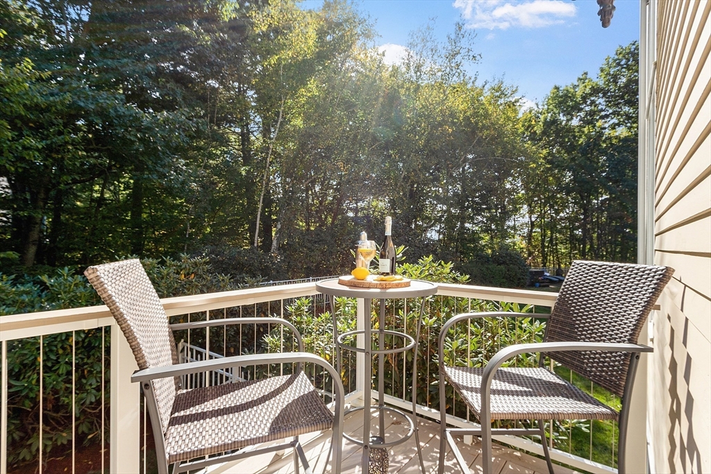 18 Bramley Hill Road Windham, NH 03087 - Photo 28 of 42 a view of a patio with table and chairs and wooden fence