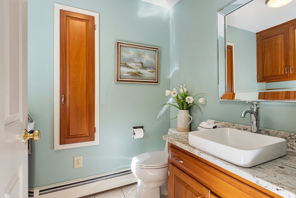 18 Bramley Hill Road Windham, NH 03087 - Photo 32 of 42 a bathroom with a granite countertop sink mirror vanity and toilet