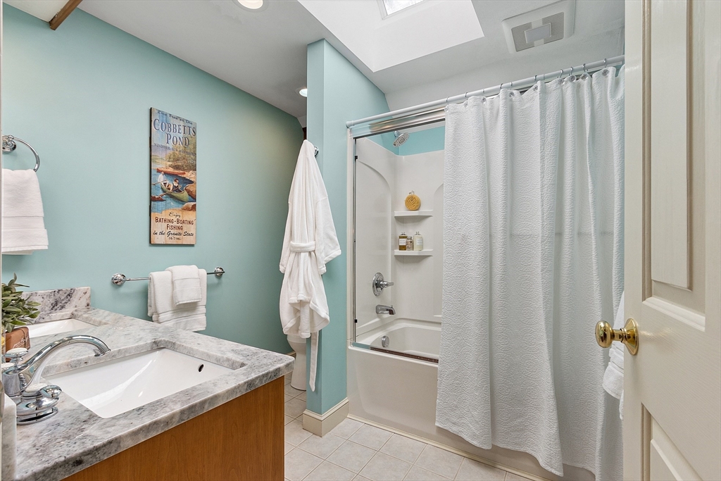 18 Bramley Hill Road Windham, NH 03087 - Photo 36 of 42 a bathroom with a sink a toilet and shower curtain
