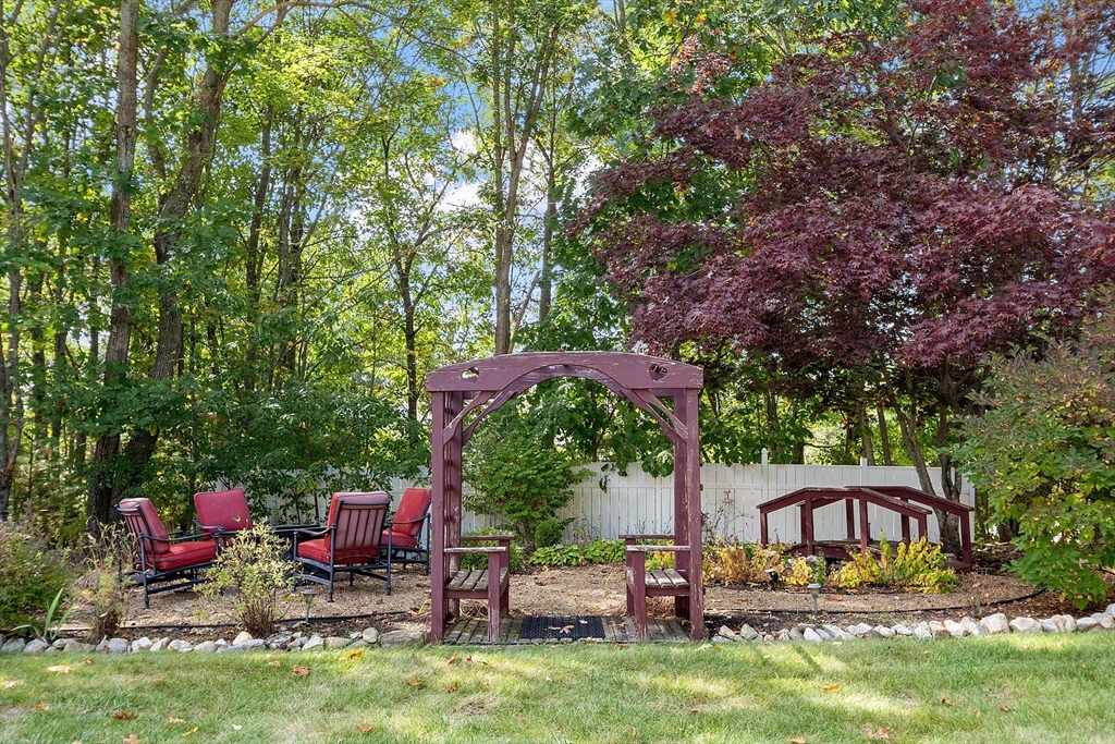 18 Bramley Hill Road Windham, NH 03087 - Photo 7 of 42 a view of a chairs and tables in the back yard of the house