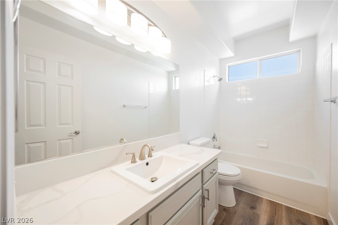 112 Iridescent Street Henderson, NV 89012 - Photo 15 of 24 A well-lit primary bathroom featuring a spacious vanity and a bathtub with shower.