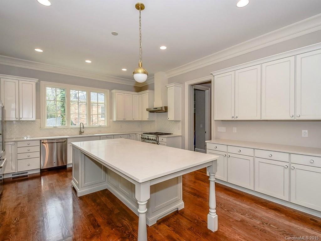 526 Ashworth Road Charlotte, NC 28211 - Photo 5 of 15 a kitchen with a sink a stove a center island and cabinets