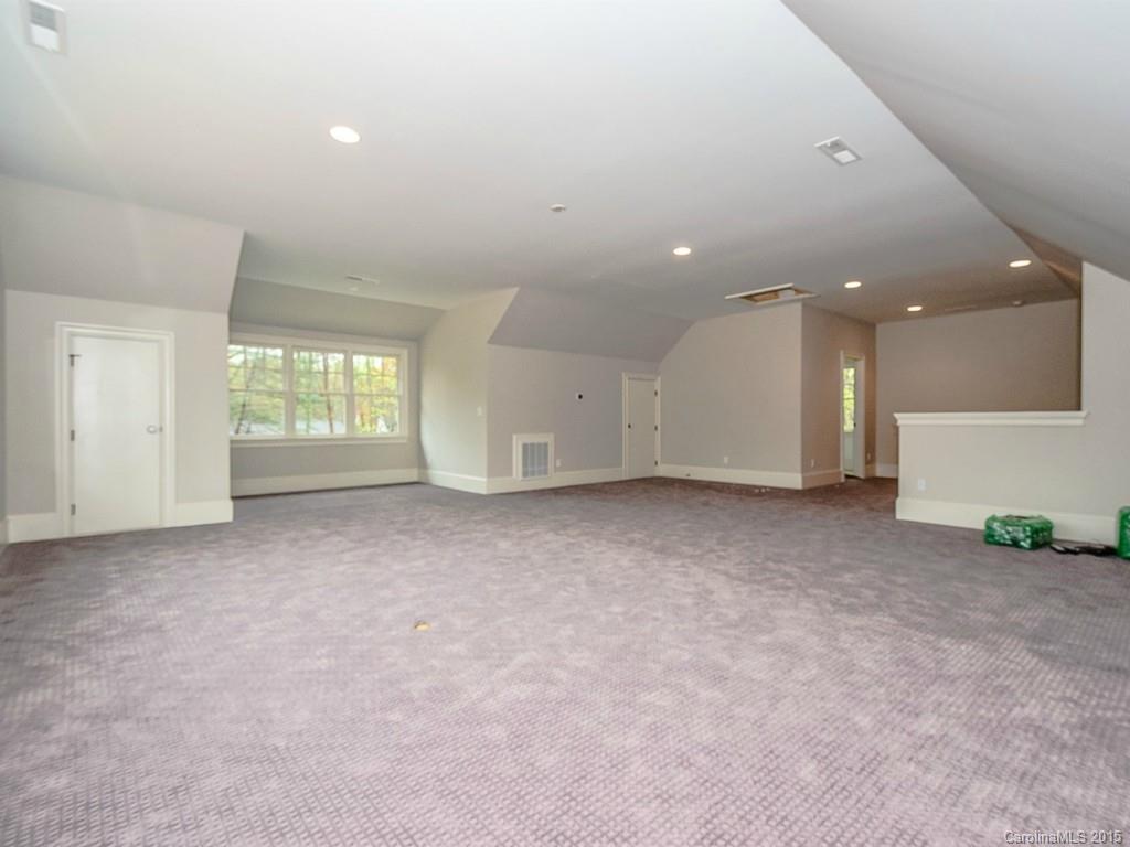 526 Ashworth Road Charlotte, NC 28211 - Photo 8 of 15 an empty room with windows and refrigerator