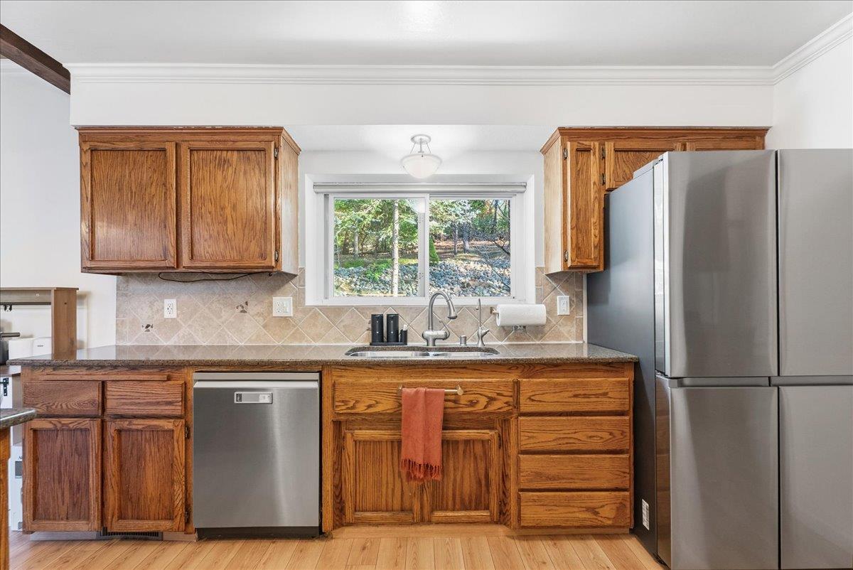 5621 Saw Mill Road Placerville, CA 95667 - Photo 21 of 75 a kitchen with stainless steel appliances granite countertop a refrigerator and a stove top oven