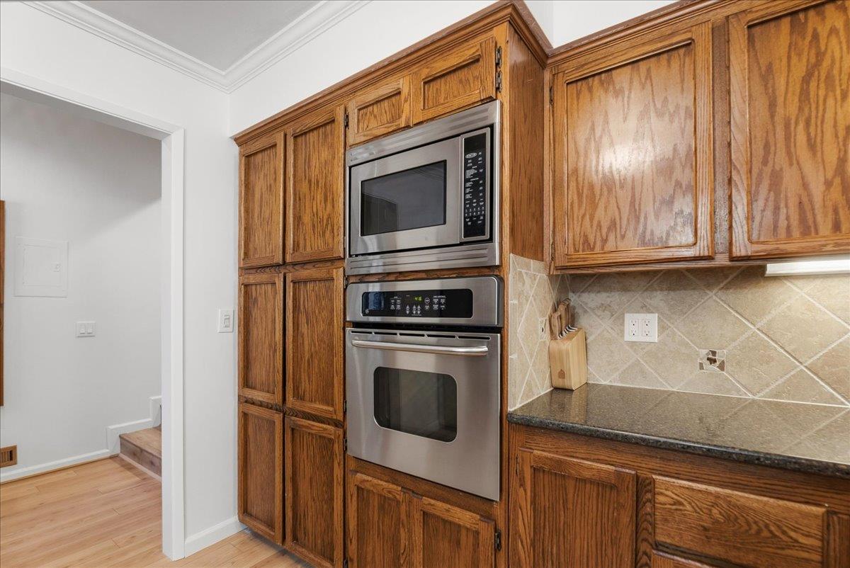 5621 Saw Mill Road Placerville, CA 95667 - Photo 22 of 75 a kitchen with granite countertop cabinets stainless steel appliances and wooden floor