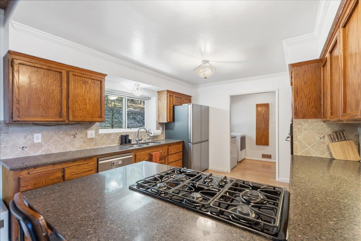 5621 Saw Mill Road Placerville, CA 95667 - Photo 23 of 75 a kitchen with stainless steel appliances granite countertop a sink stove and refrigerator