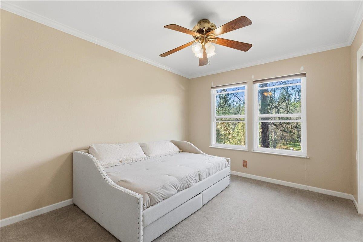 5621 Saw Mill Road Placerville, CA 95667 - Photo 28 of 75 a bedroom with a large bed and a large window