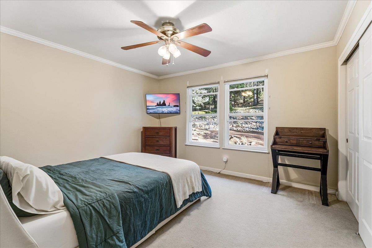 5621 Saw Mill Road Placerville, CA 95667 - Photo 29 of 75 a spacious bedroom with a bed and a chandelier
