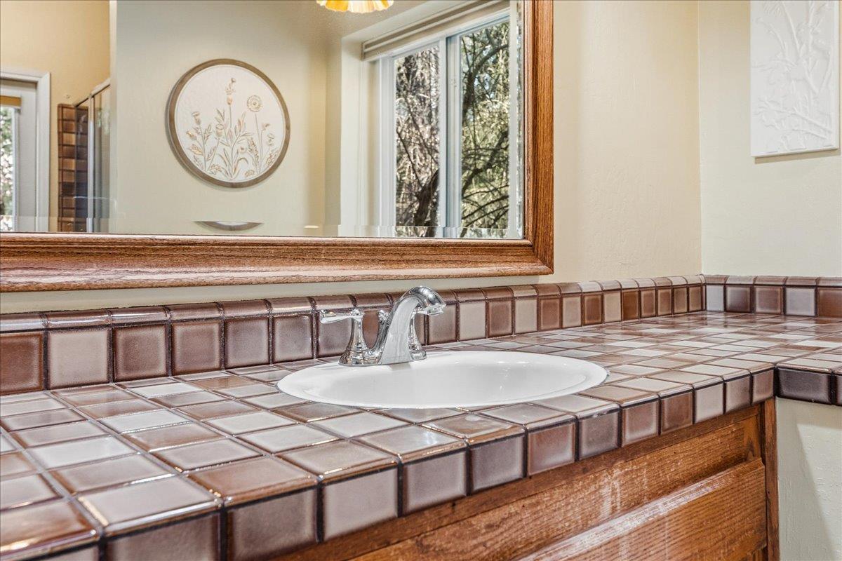 5621 Saw Mill Road Placerville, CA 95667 - Photo 35 of 75 a living room with a table a clock and a clock