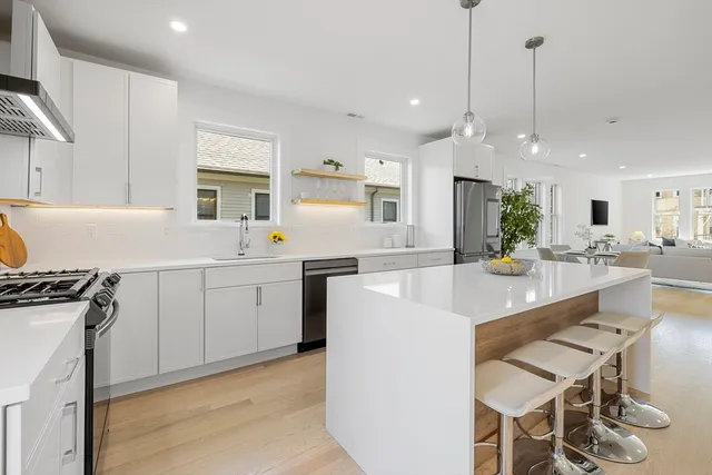 a kitchen with a sink stove and white cabinets