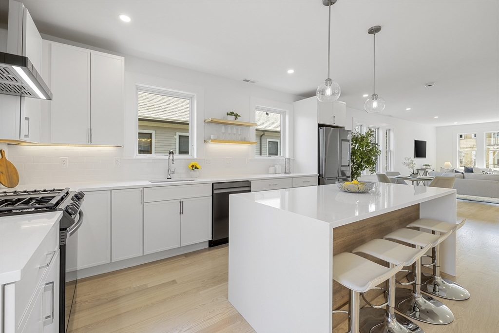 a kitchen with a sink stove and white cabinets