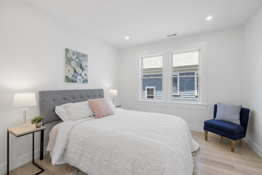 39 Seven Pines Avenue, Unit 39 Cambridge, MA 02140 - Photo 12 of 42 a bedroom with a bed and wooden floor