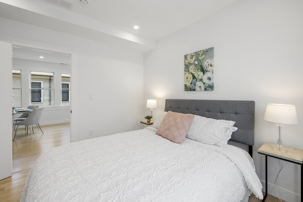39 Seven Pines Avenue, Unit 39 Cambridge, MA 02140 - Photo 14 of 42 a bedroom with a bed and wooden floor