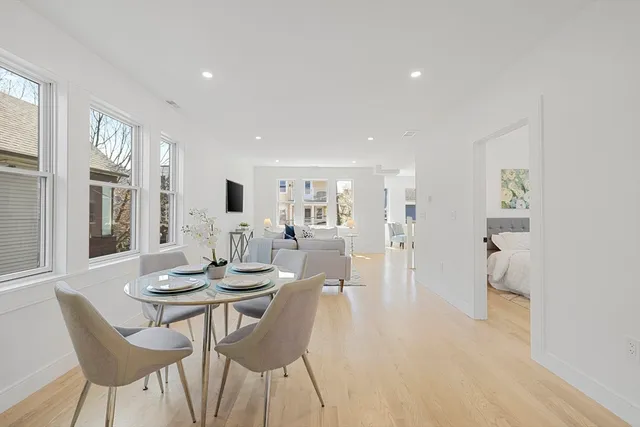 a view of a dining room with furniture and wooden floor