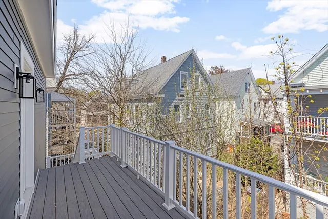 a view of balcony with wooden floor and fence