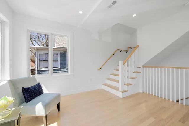 a view of a livingroom with furniture and staircase