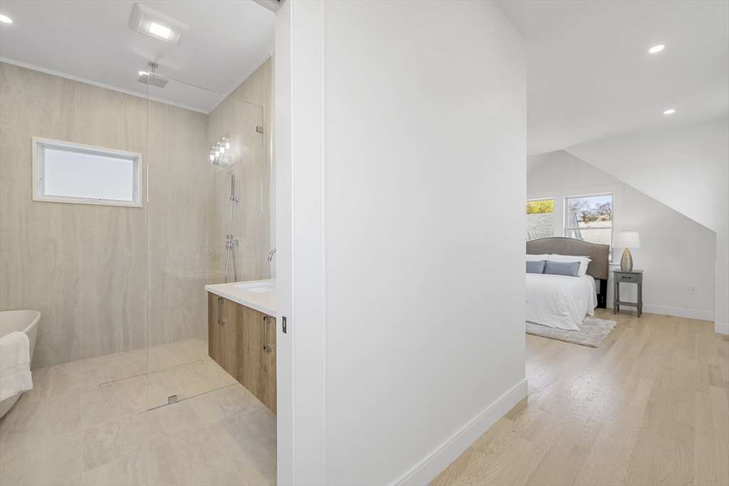 39 Seven Pines Avenue, Unit 39 Cambridge, MA 02140 - Photo 36 of 42 a hallway with white cabinets and wooden floor