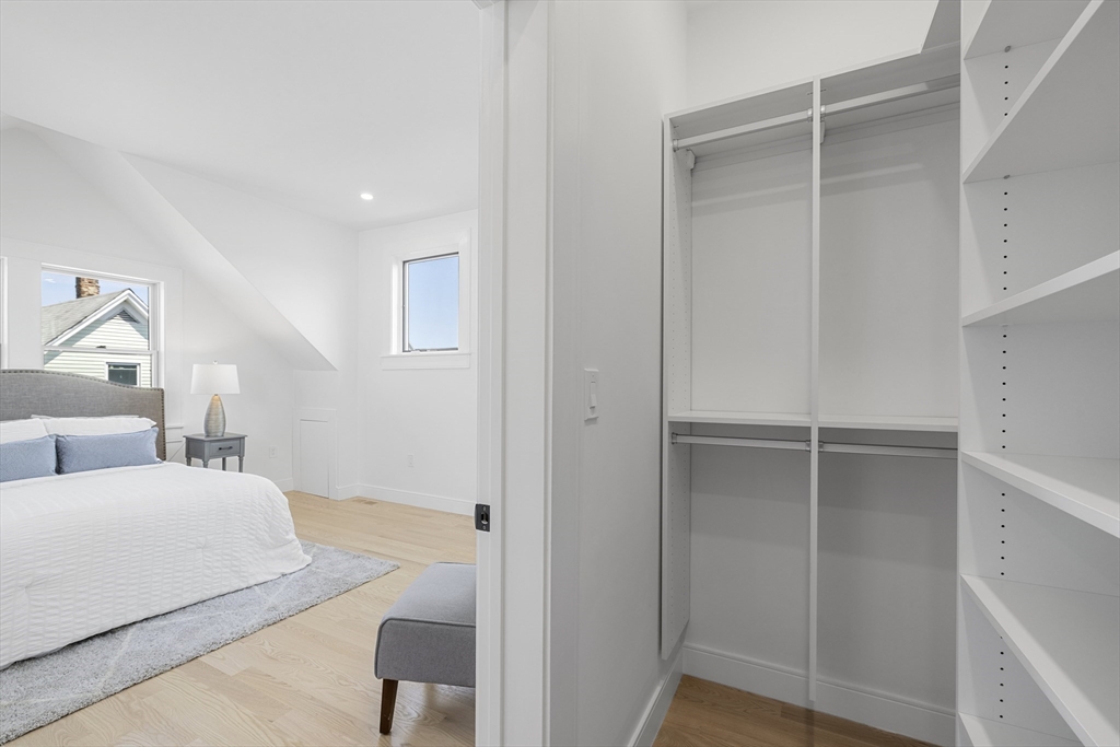 39 Seven Pines Avenue, Unit 39 Cambridge, MA 02140 - Photo 38 of 42 a bedroom with a bed and a walk in closet