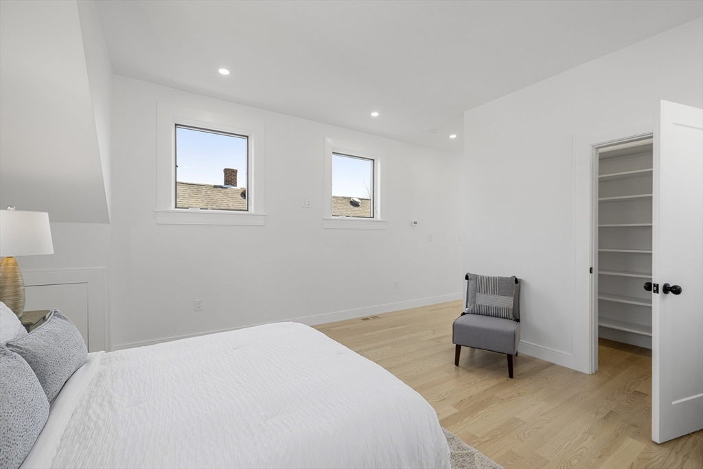 39 Seven Pines Avenue, Unit 39 Cambridge, MA 02140 - Photo 40 of 42 a bedroom with a bed and a chair