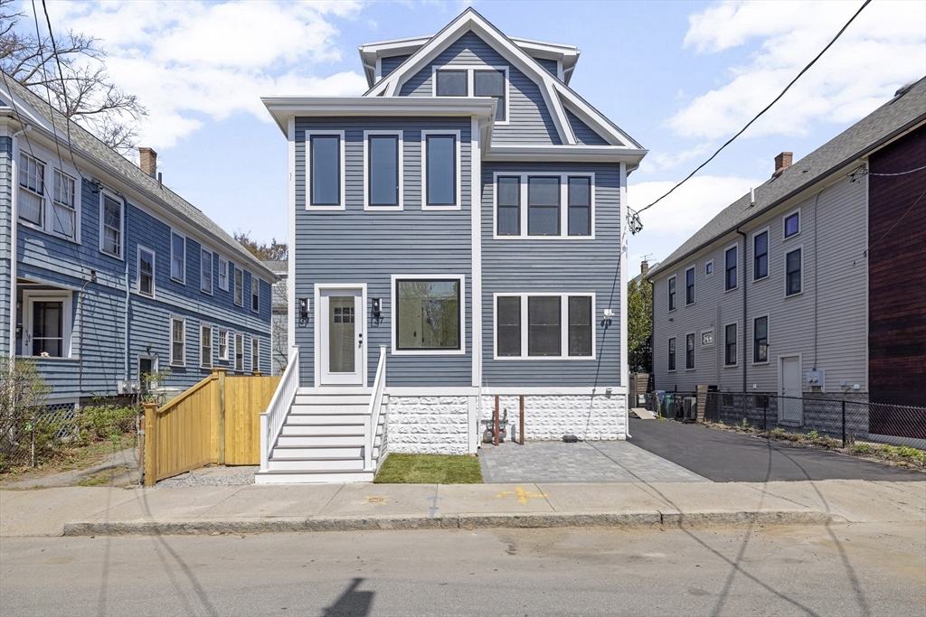 39 Seven Pines Avenue, Unit 39 Cambridge, MA 02140 - Photo 6 of 42 a front view of a residential apartment building with a yard