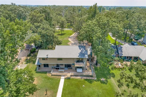 an aerial view of a house with swimming pool garden and patio