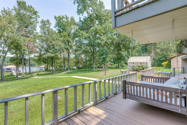 a view of a wooden deck and a yard