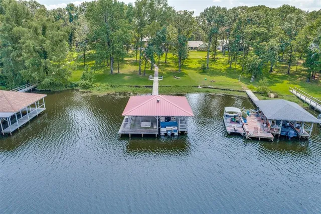 a backyard of a house with a yard and outdoor seating