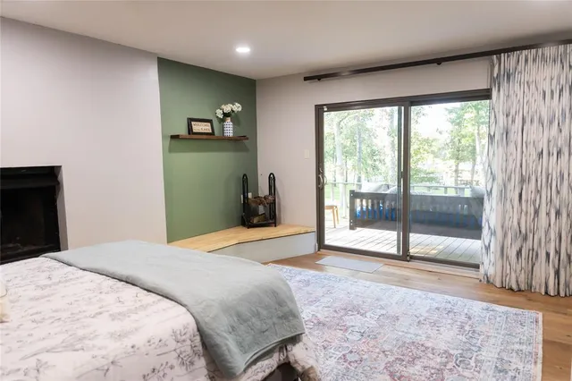 a bedroom with a bed and a large window