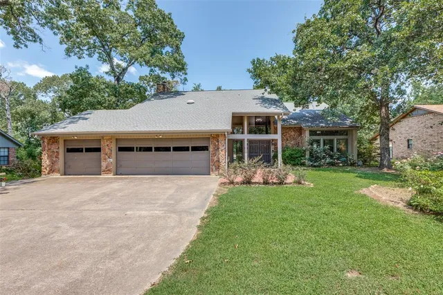 front view of a house with a garden and yard