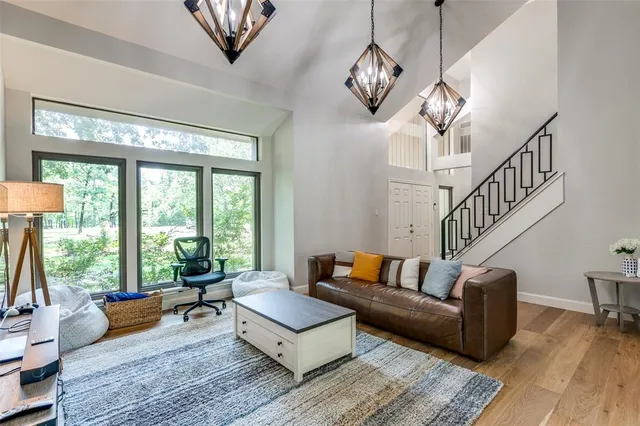 a living room with furniture a table and a large window