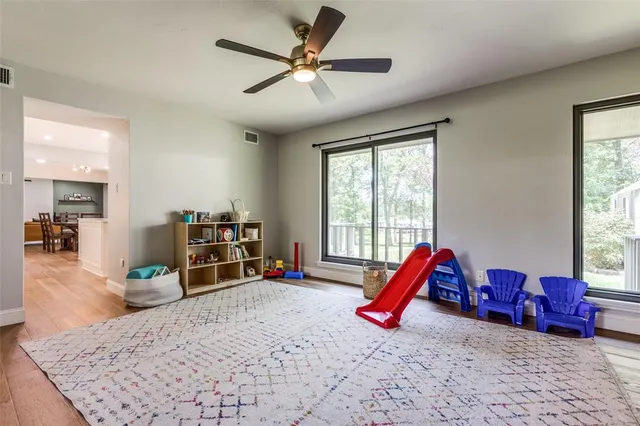 a living room with furniture a flat screen tv and a large window