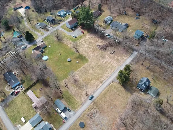 an aerial view of a residential houses with outdoor space