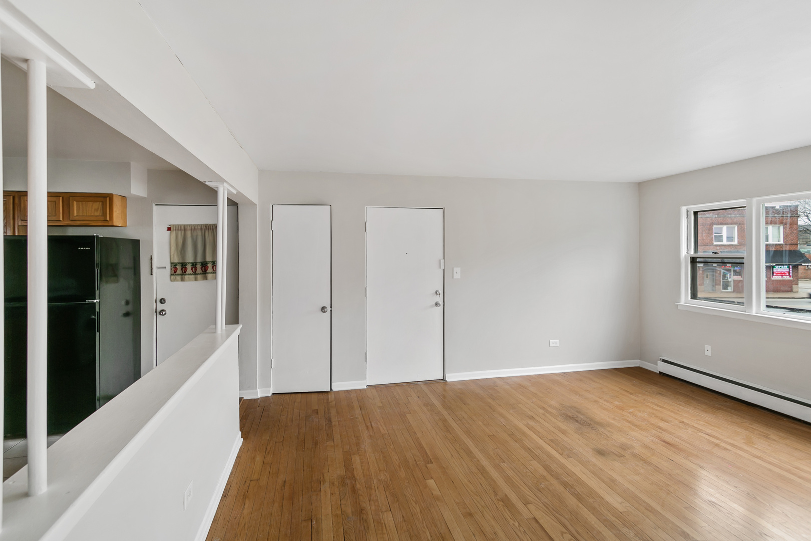 805 North 22nd Avenue, Unit 4 Melrose Park, IL 60160 - Photo 2 of 9 a view of an empty room with window and wooden floor
