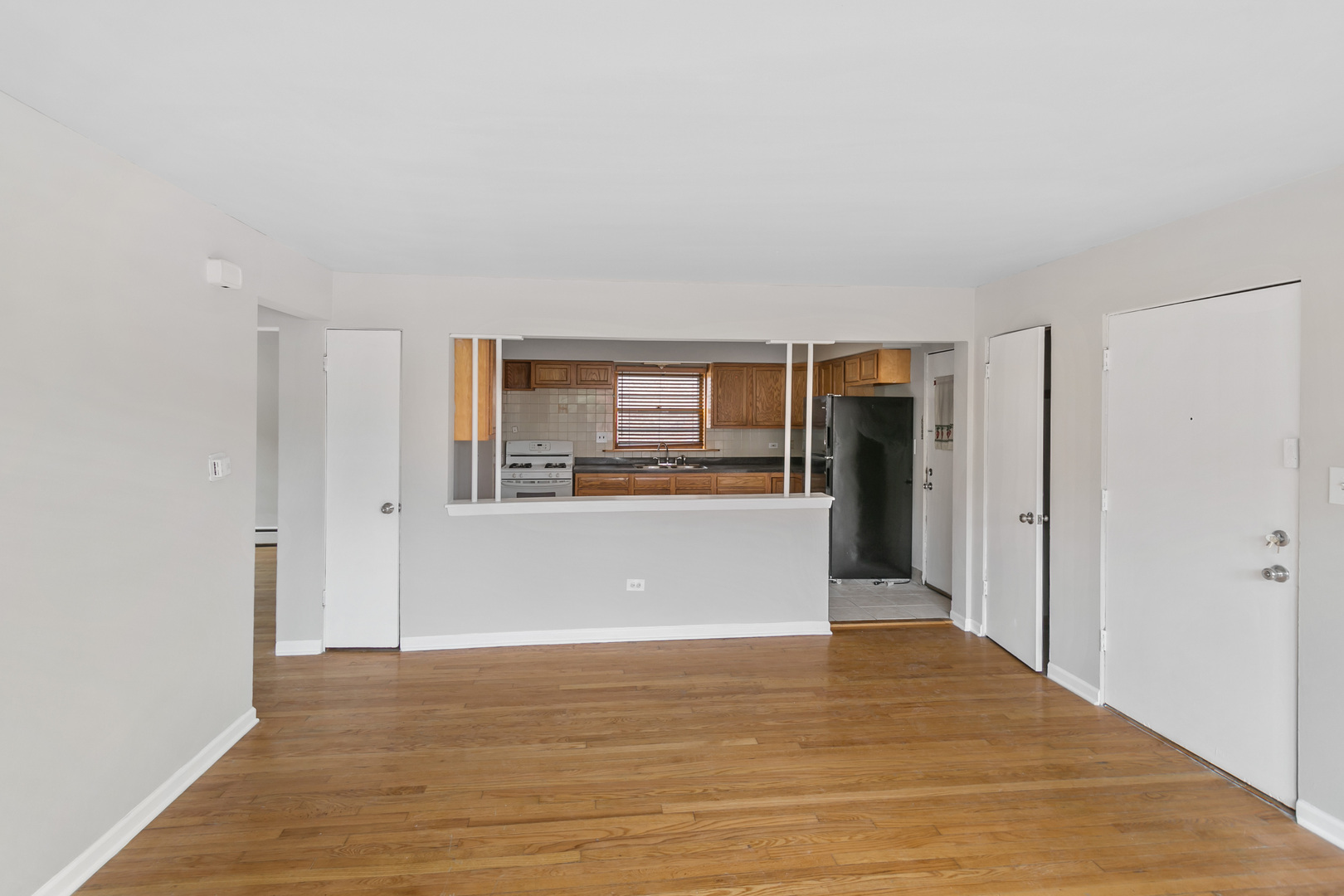 805 North 22nd Avenue, Unit 4 Melrose Park, IL 60160 - Photo 4 of 9 a view of a big room with wooden floor and windows