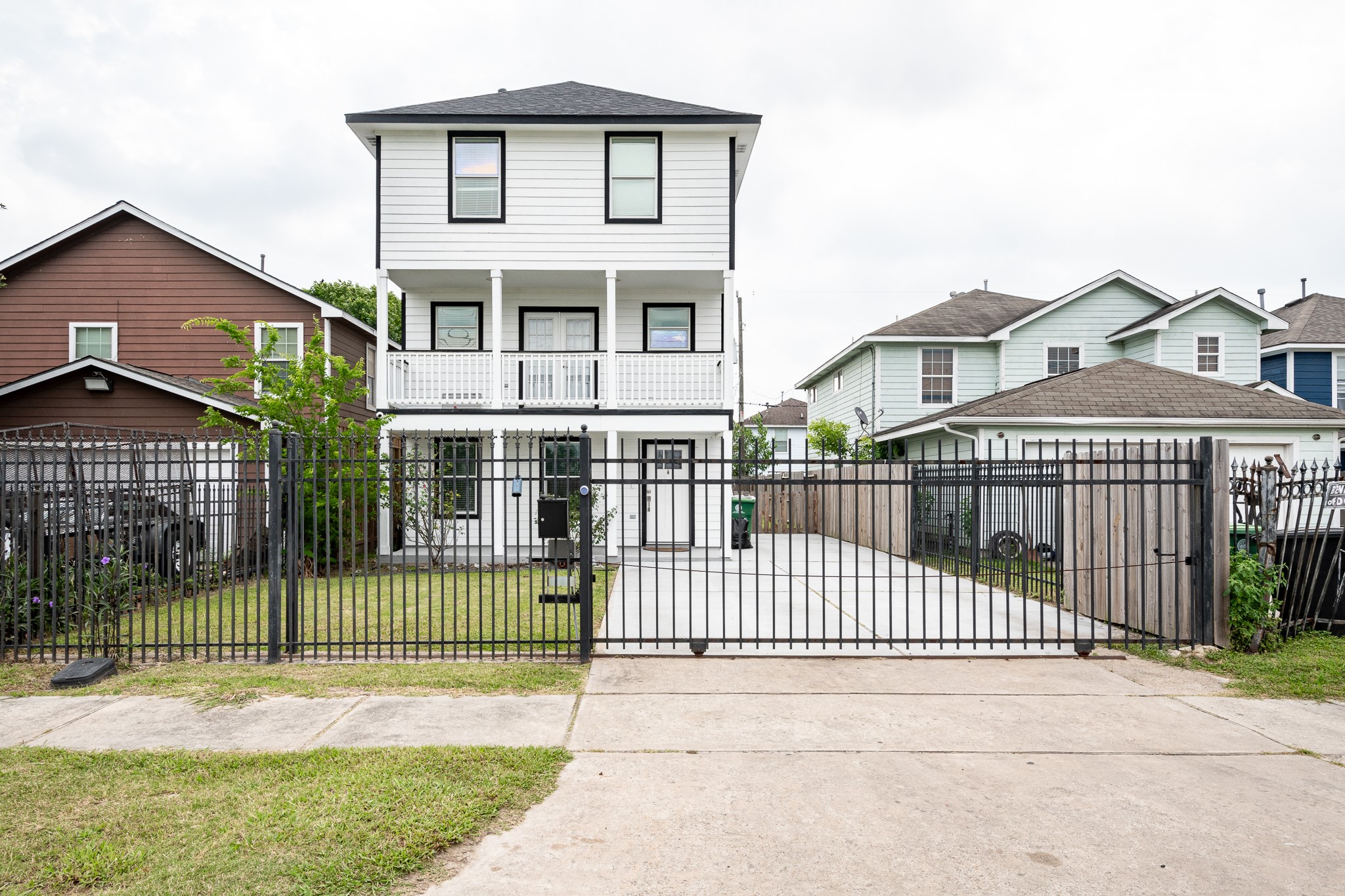 9026 McGallion Road Houston, TX 77022 - Photo 1 of 34 a view of a brick house with a small garden